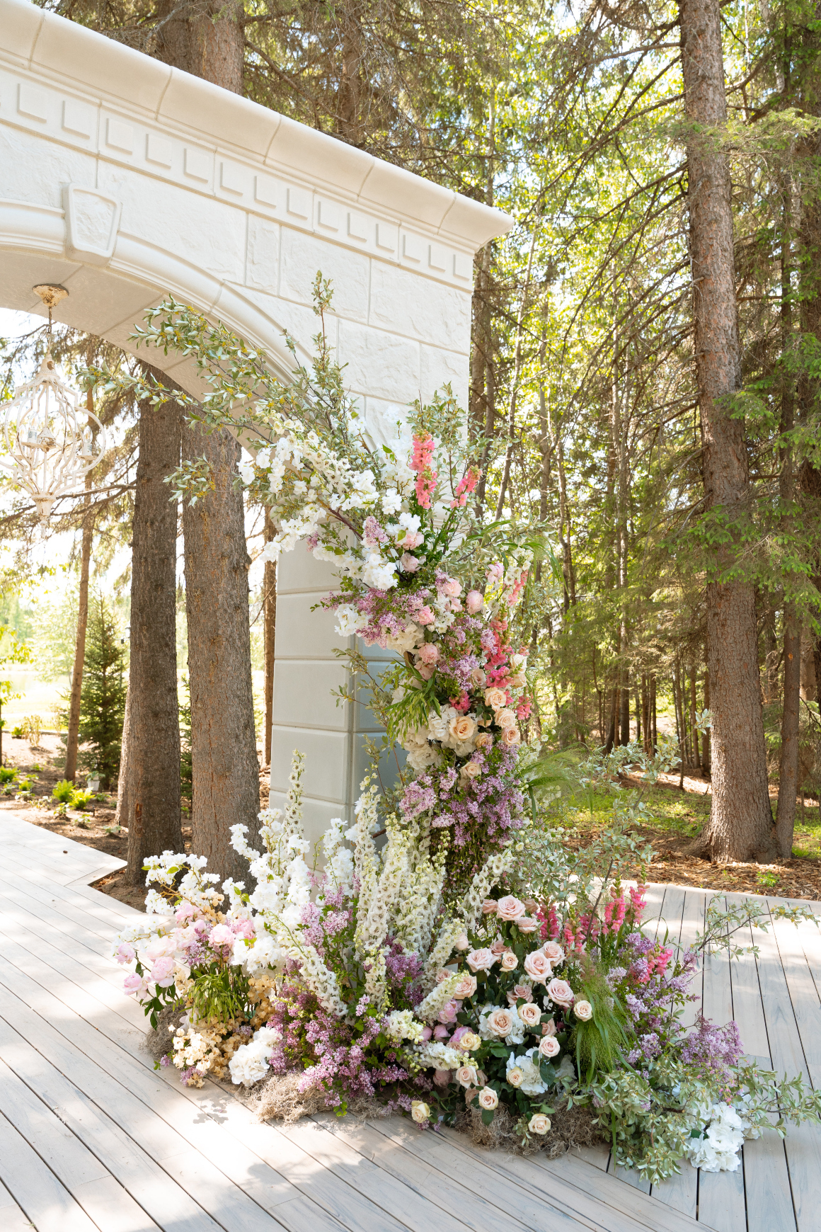 Floral instalment on one side of the archway, designed in an organic style as though the flowers were growing up from the base.