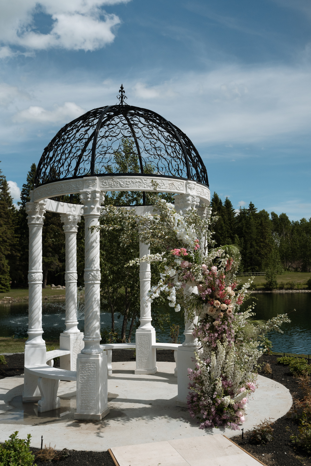 A stunning white marble gazebo with picturesque backdrops of the 1 acre pond and fountain.