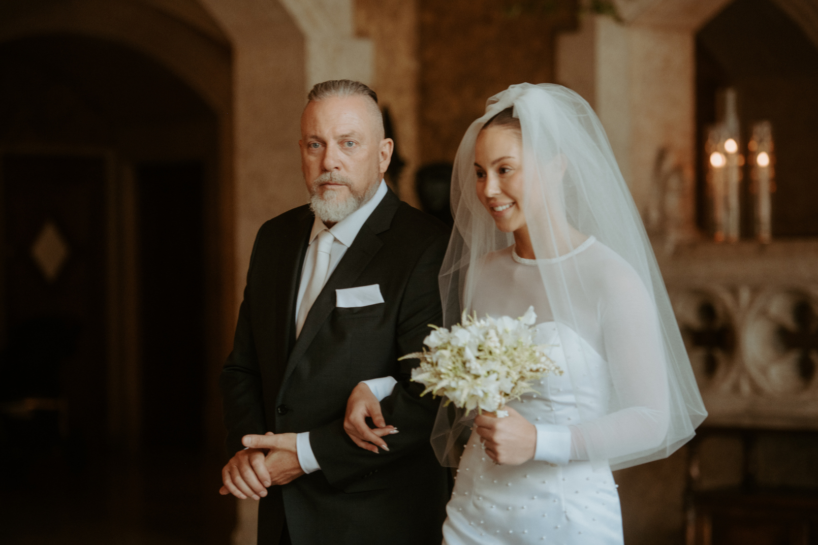 Tyller and her father making their way down the aisle to Carter.