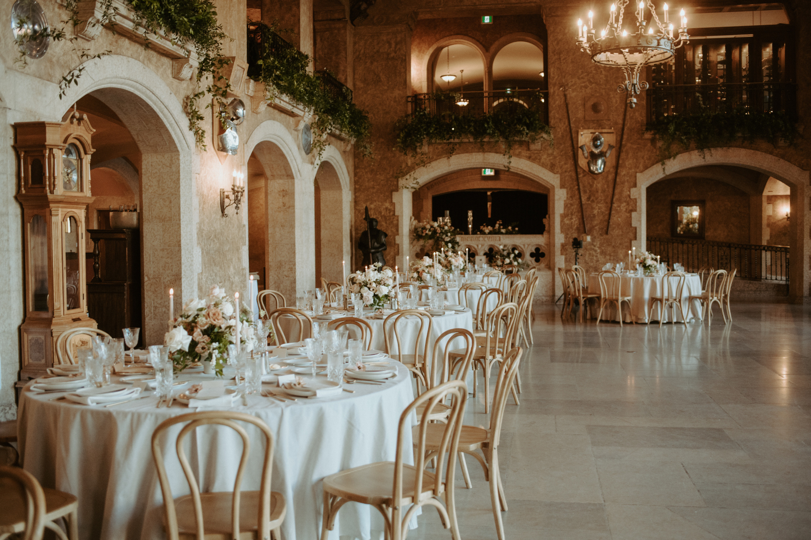 The hall beautifully set up with all the guest tables in a row, with a number of ornate archways bordering the hall.