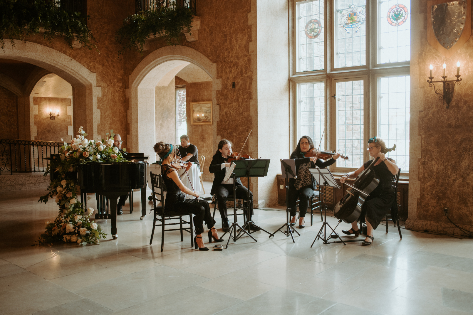 The stringed quartet playing at the ceremony, next to the piano with it's big beautiful arrangements.