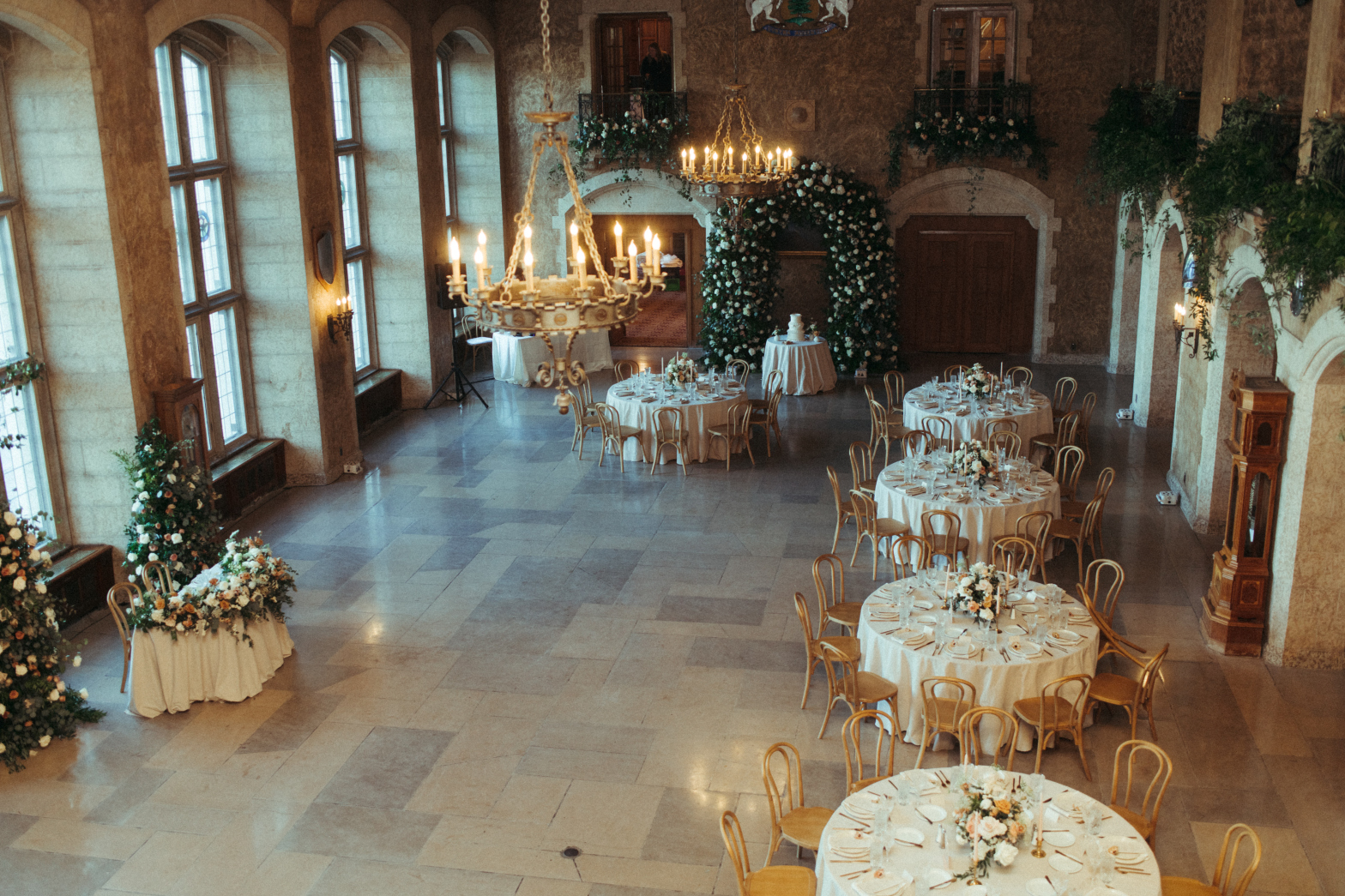 The view of the reception set up from up at one of the balconies, showing the guest tables, dance floor, sweetheart table, cake table and balcony arrangements.