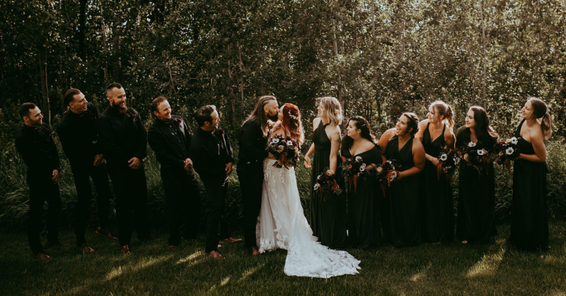 Haley and Greg share a kiss, while their wedding party are all leaning to look at them, clearly happy for the couple.