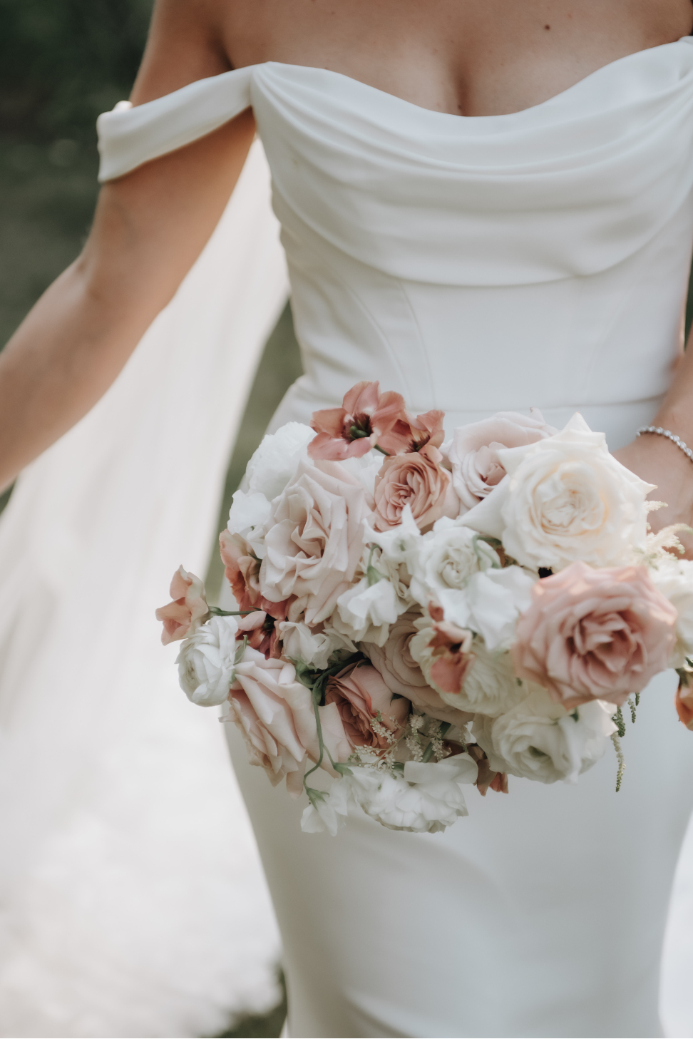 A timeless bridal bouquet filled with different varieties of roses, ranunculus, sweet peas, lisianthus and astilbe