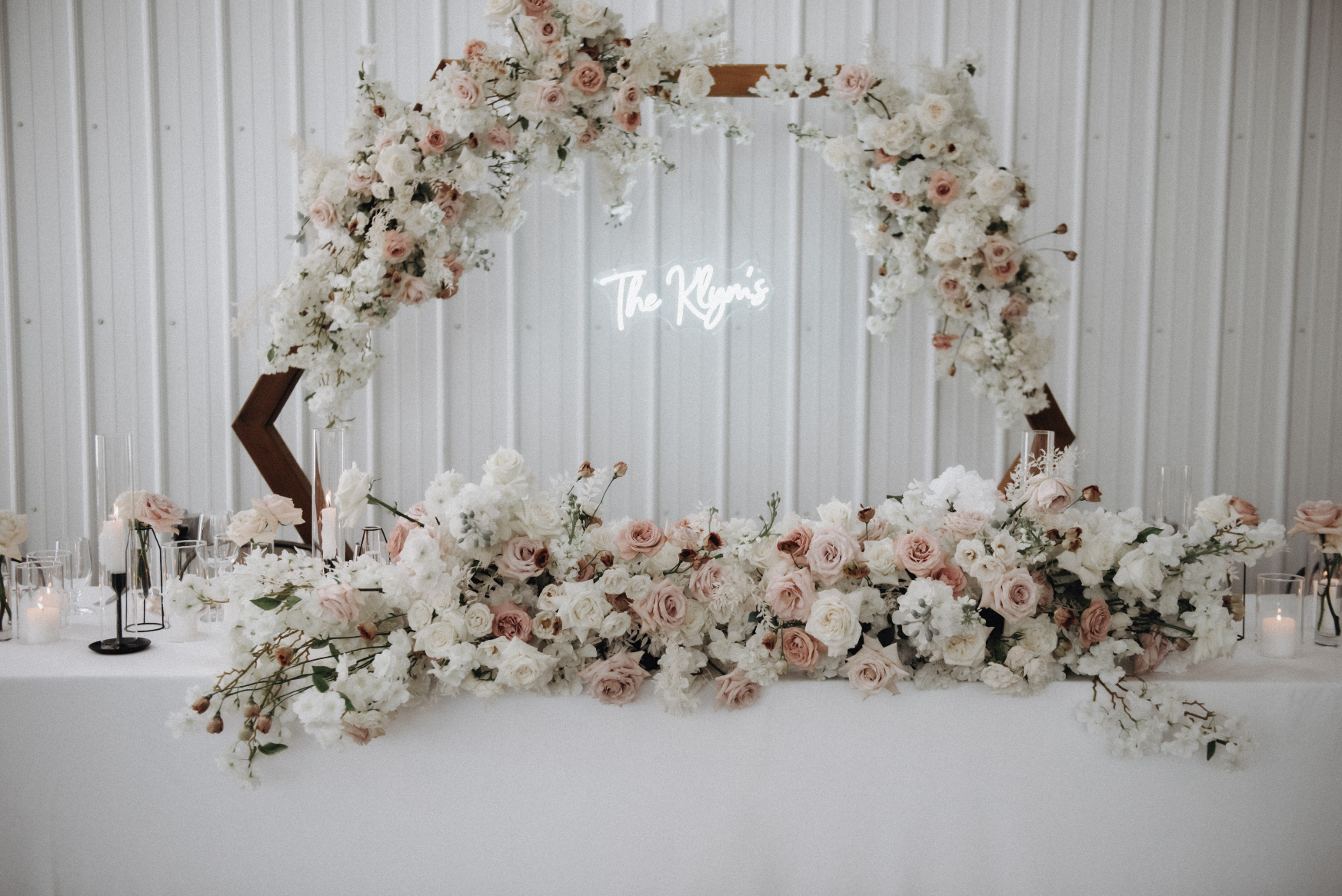 A close up of the stunning hexagon arch as well as the arrangement at the front of the head table in front of where the bride and groom sat.