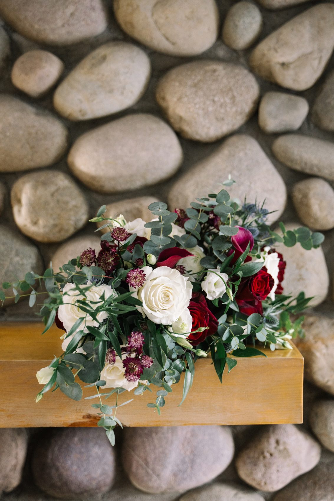Bouquet Beautiful bouquet of roses, ranunculus, astrantia, eryngium, lisianthus with lots of lavish Italian ruscus and eucalyptus for foliage.