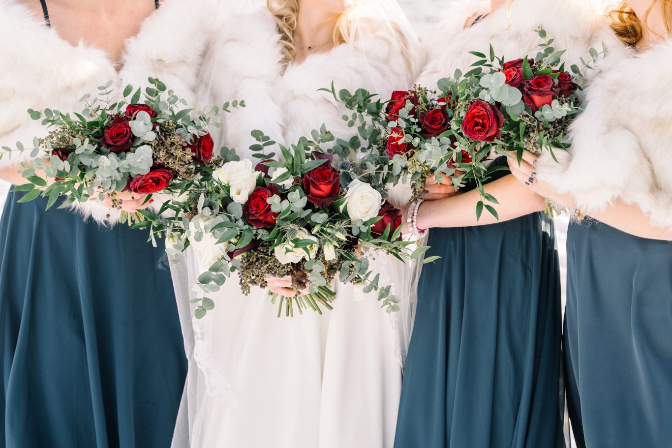 Bouquets Our bride, Courtney, with her bridesmaids in their cute fur stoles, holding their romantic ivory and burgundy bouquets.