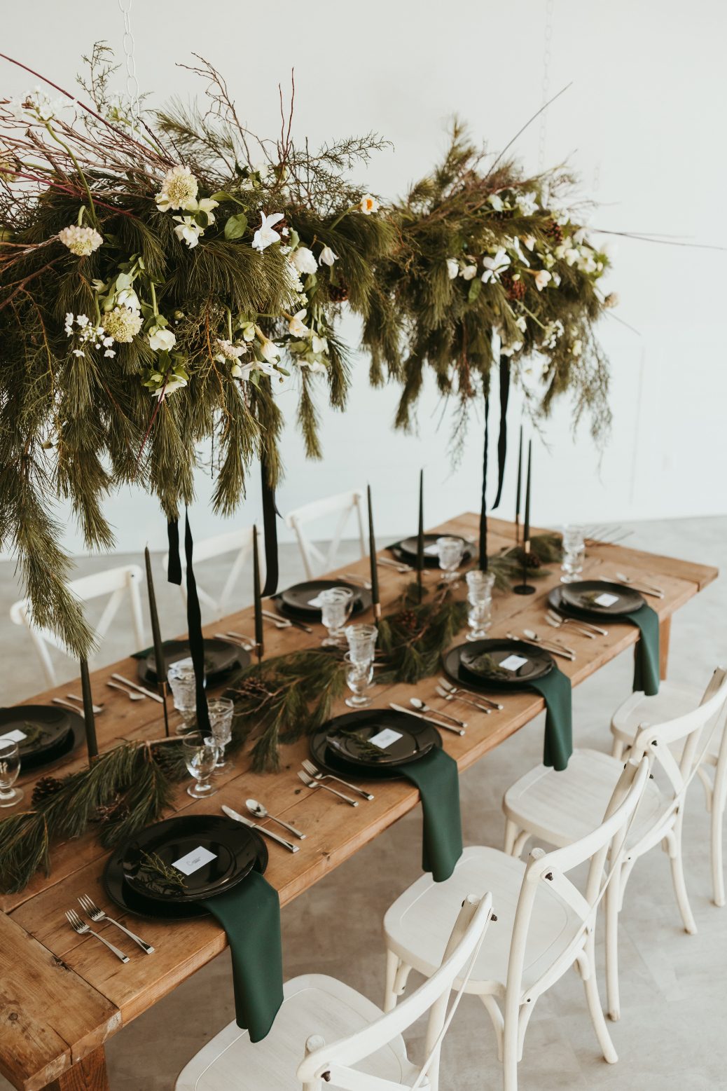 A more detailed shot of the stunning suspended centrepiece full of winter greens, branches, frill tulips, scabiosa, daffodils, hellebores, allium, clematis and pinecones.