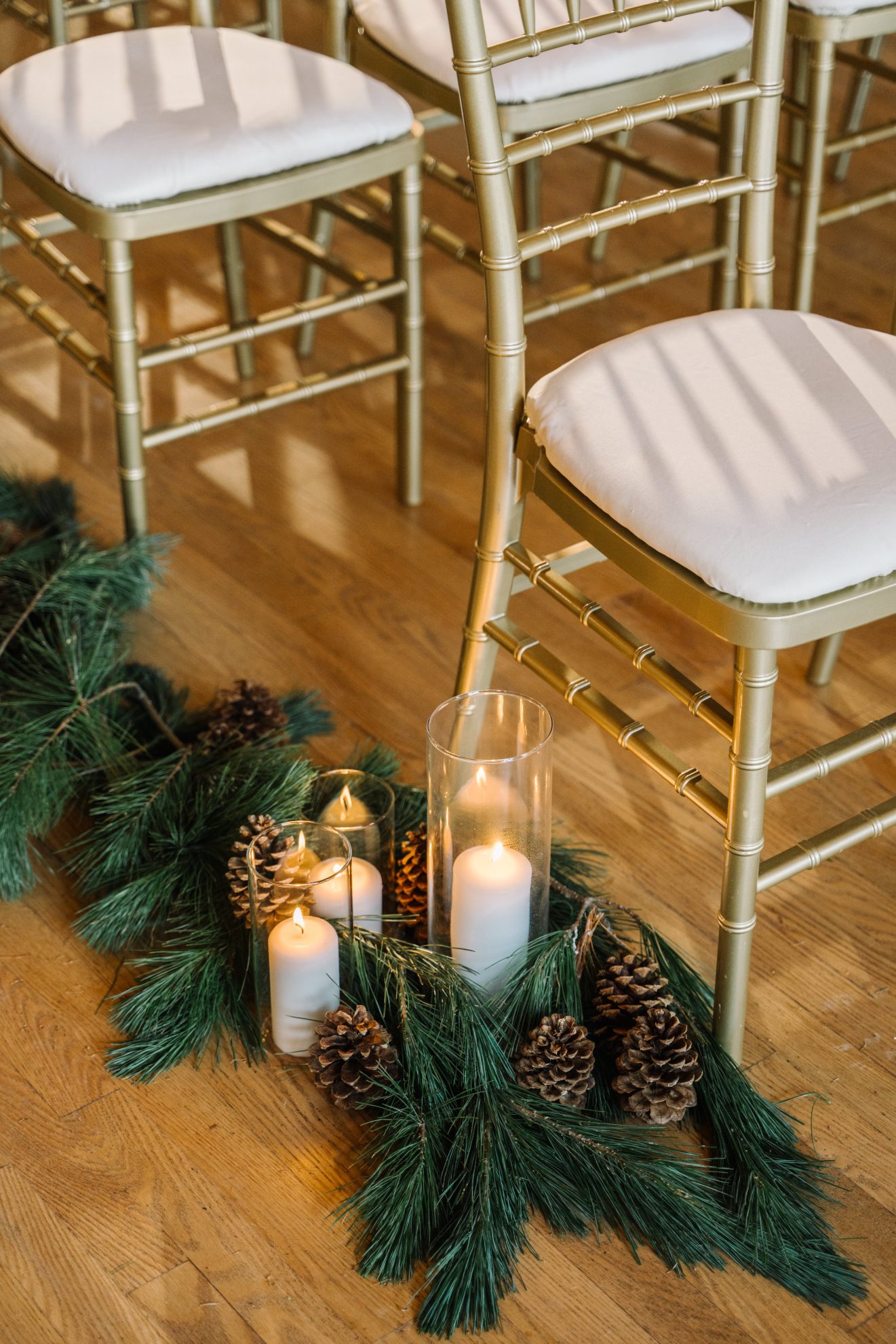 Calgary Wedding and Portrait Photographer The aisle was lined with aromatic pine boughs and accented with clusters of pine cones and pillar candles.