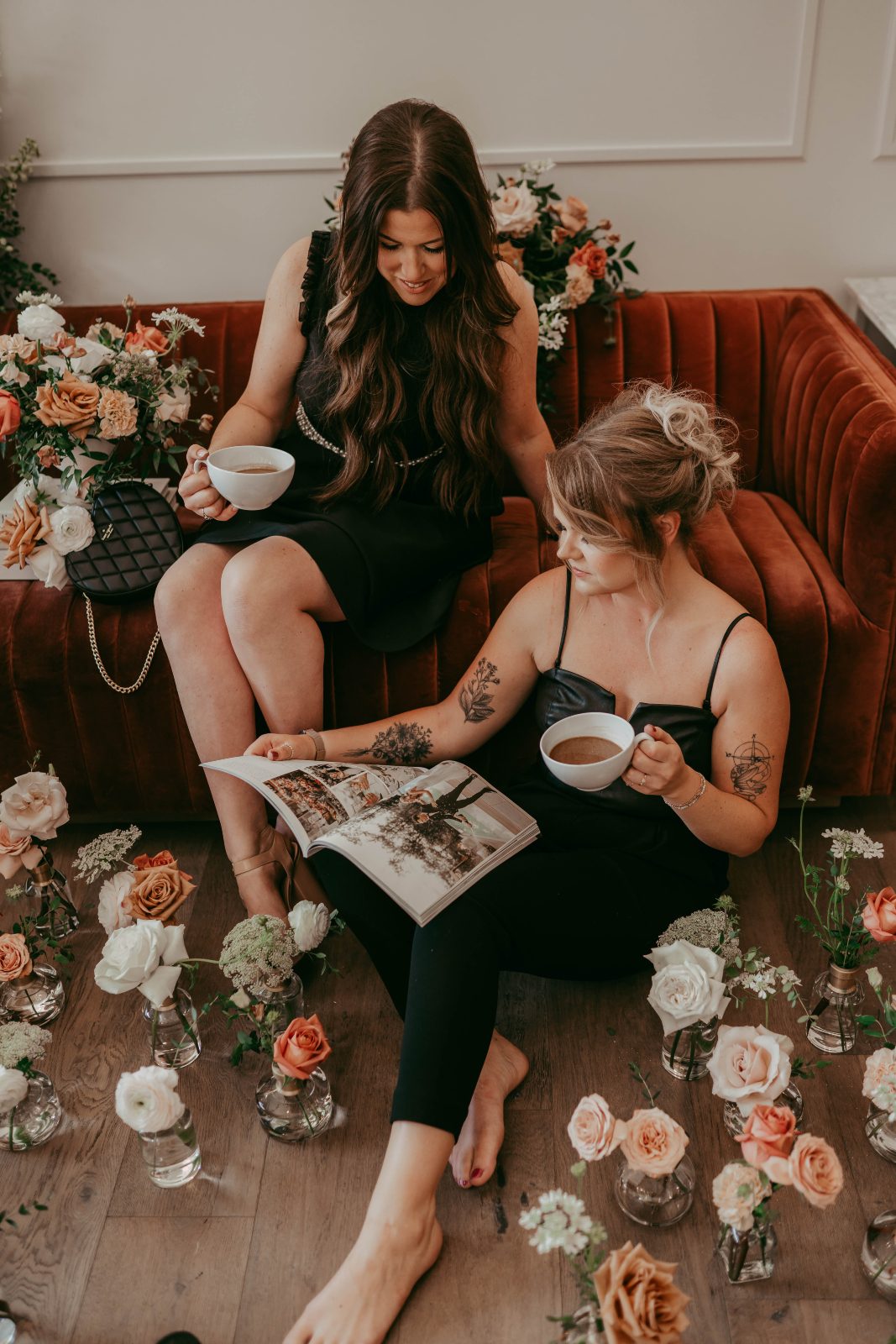 Travis and Erin are checking out a bridal magazine, sipping coffees surrounded by Calyx flowers