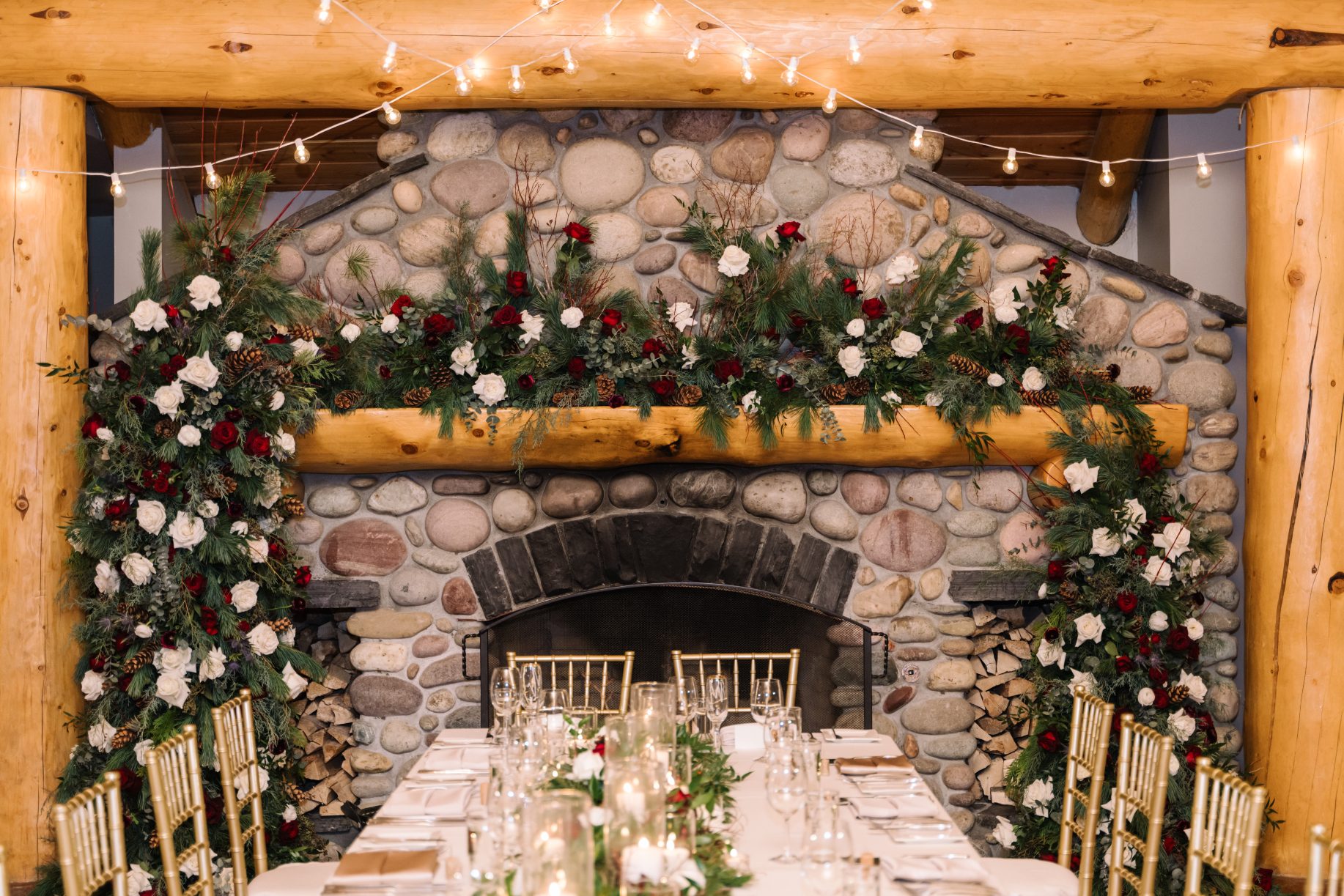 Mantel Arrangement + Arch An elaborate arrangement adorned the mantel of the fireplace, and the arch pieces from the ceremony framed it. The head table had an exquisite table runner of greens, flowers and candles running the length of the table.