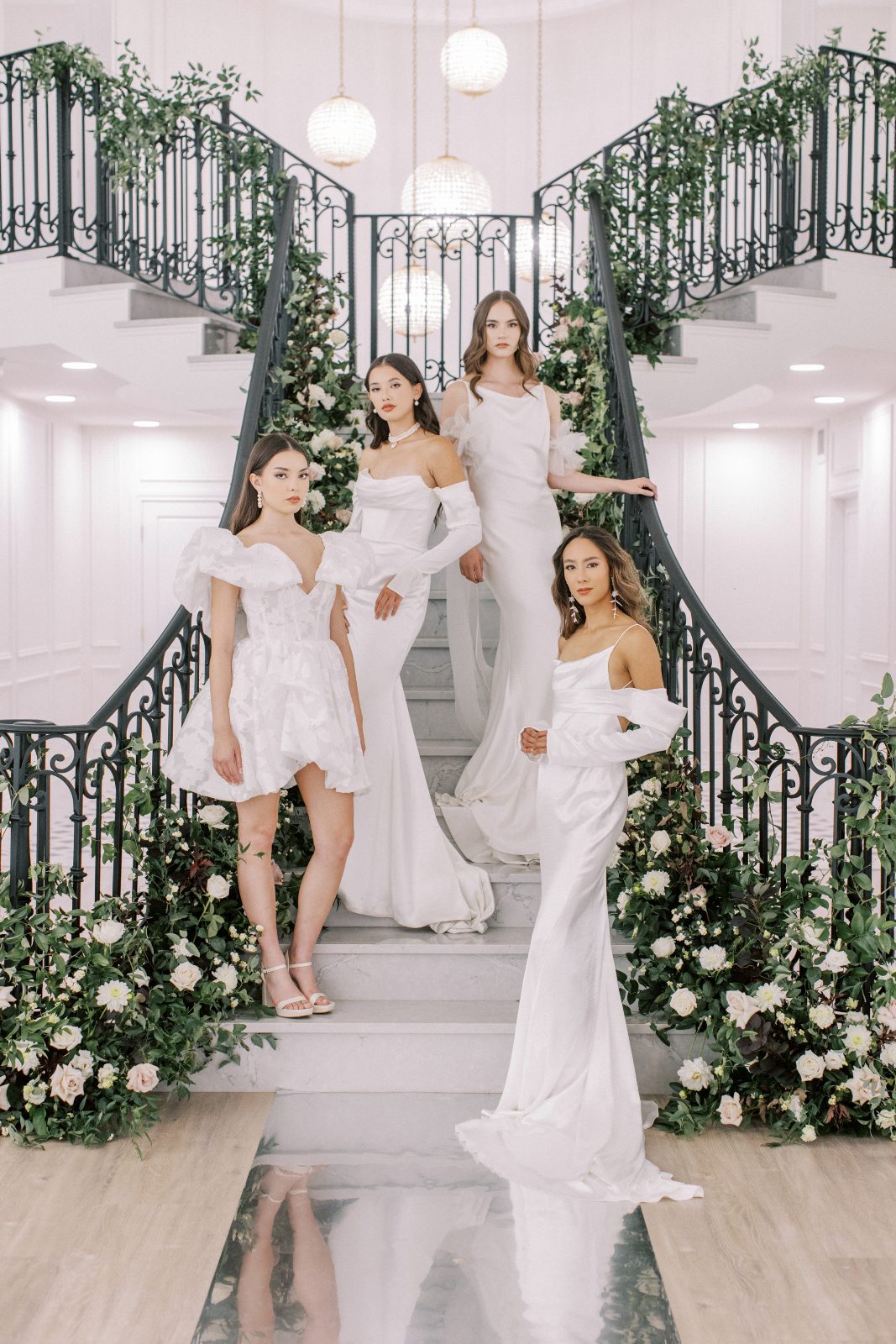 All of our models posing together on the gorgeous staircase at Archway Manor.