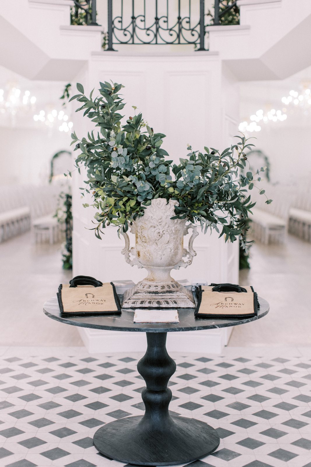 A gorgeous urn of all greens as a focal point of the welcoming table in the foyer of Archway Manor
