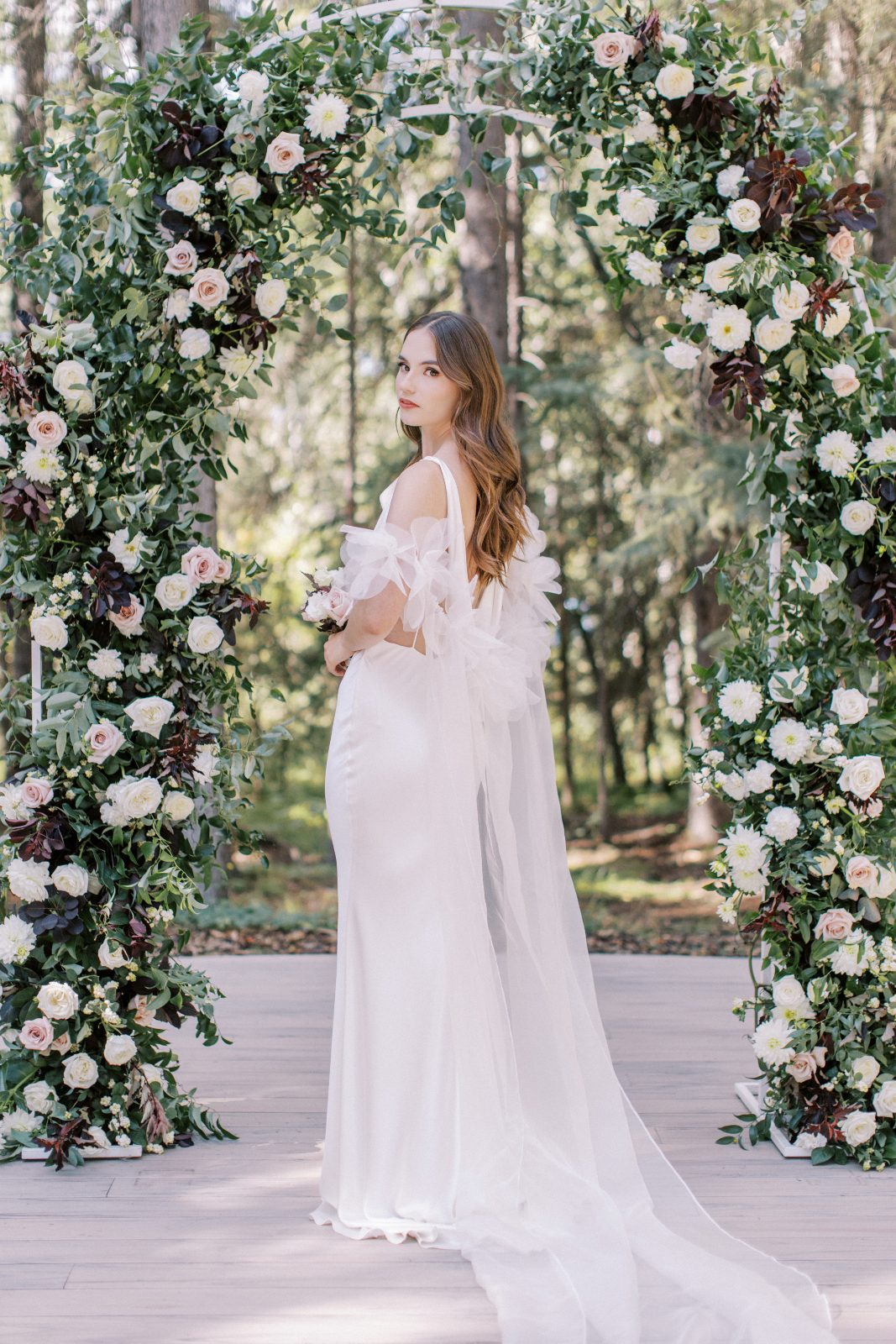 She turns around so you can see the stunning design of the dress from the back side as she turns her head to look at the camera.