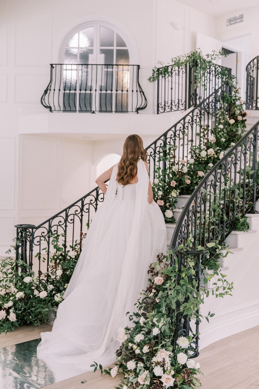 One of the models returning up the staircase with stunning layers of fabric pooling behind her looking very regal.