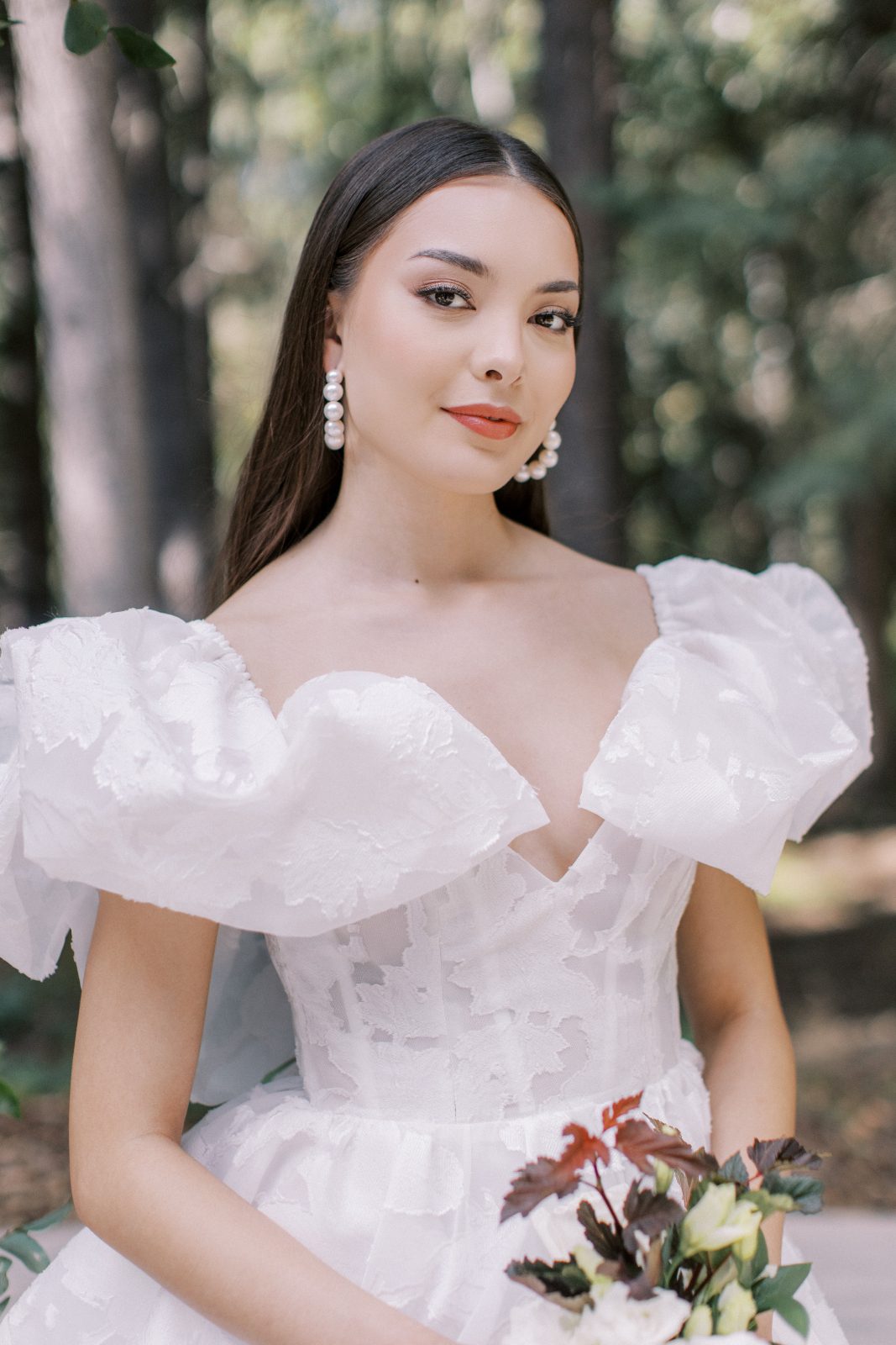 A close up of the fabulous dress with an elegant tight bodice with big dramatic ruffles.