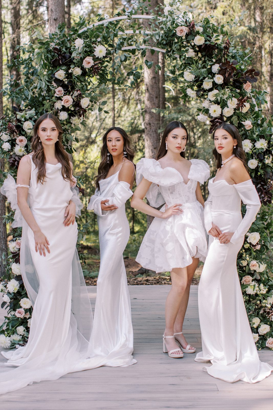 All four models strike a pose under the outdoor arch in their fabulous gowns.