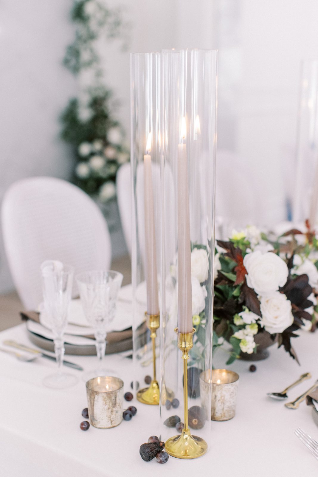 Beautiful accents on the table include taupe tapers in hurricane vases, golden votive candles and rich toned seasonal fruit.