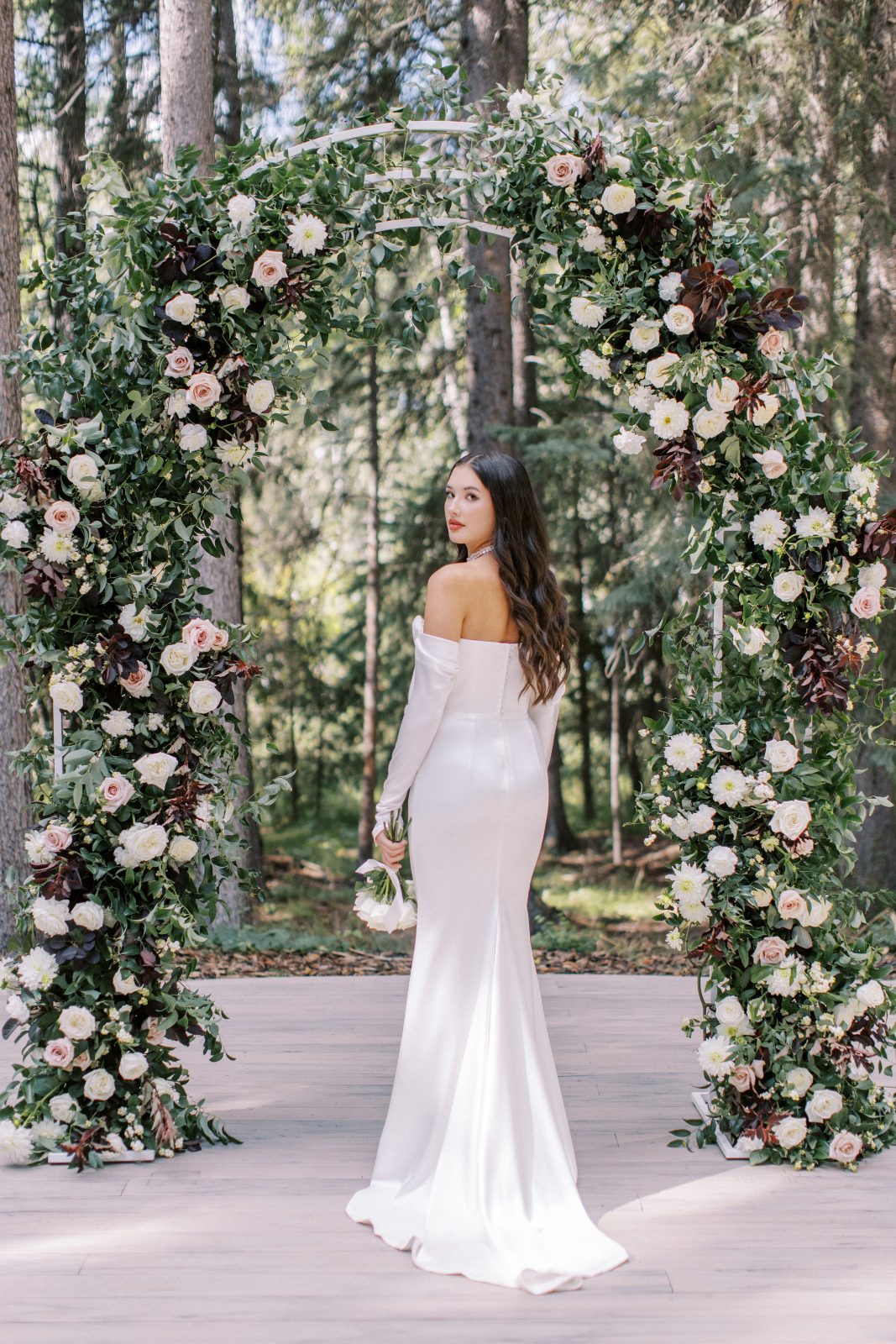 A sleek elegant gown draping beautifully over the models gentle curves with stylish detached sleeves.