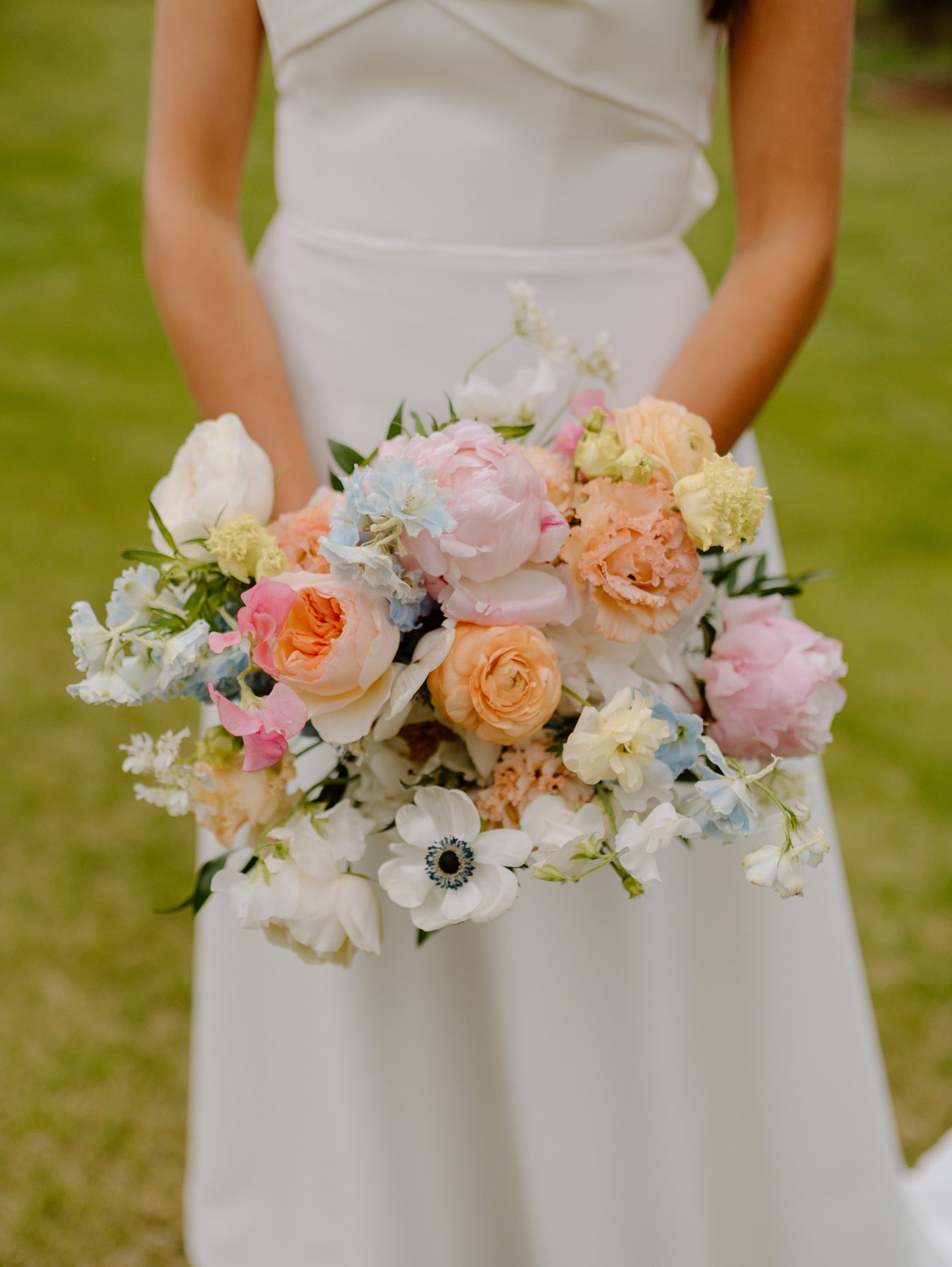 Mya's stunning spring bouquet featuring roses, anemones, peonies, ranunculus, lisianthus, sweet peas, and delphinium.