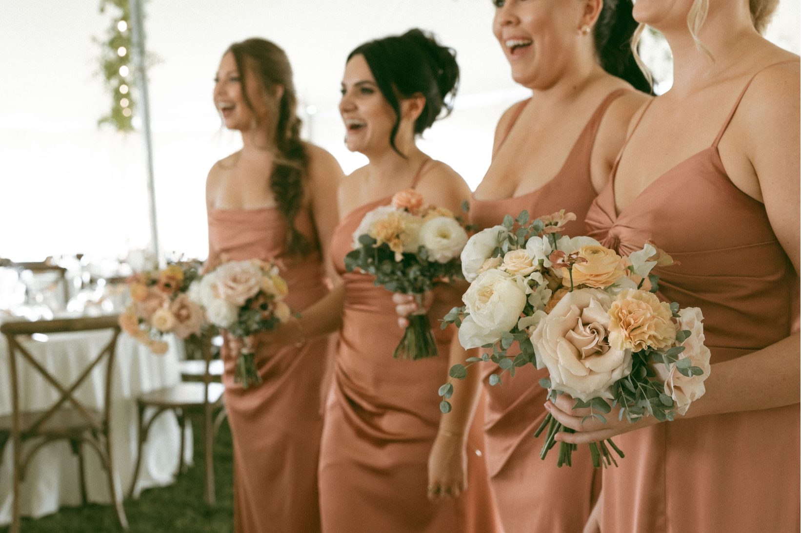 The bridesmaids lined up, laughing, looking gorgeous in their gowns, with a more detailed picture of their beautiful bouquets.