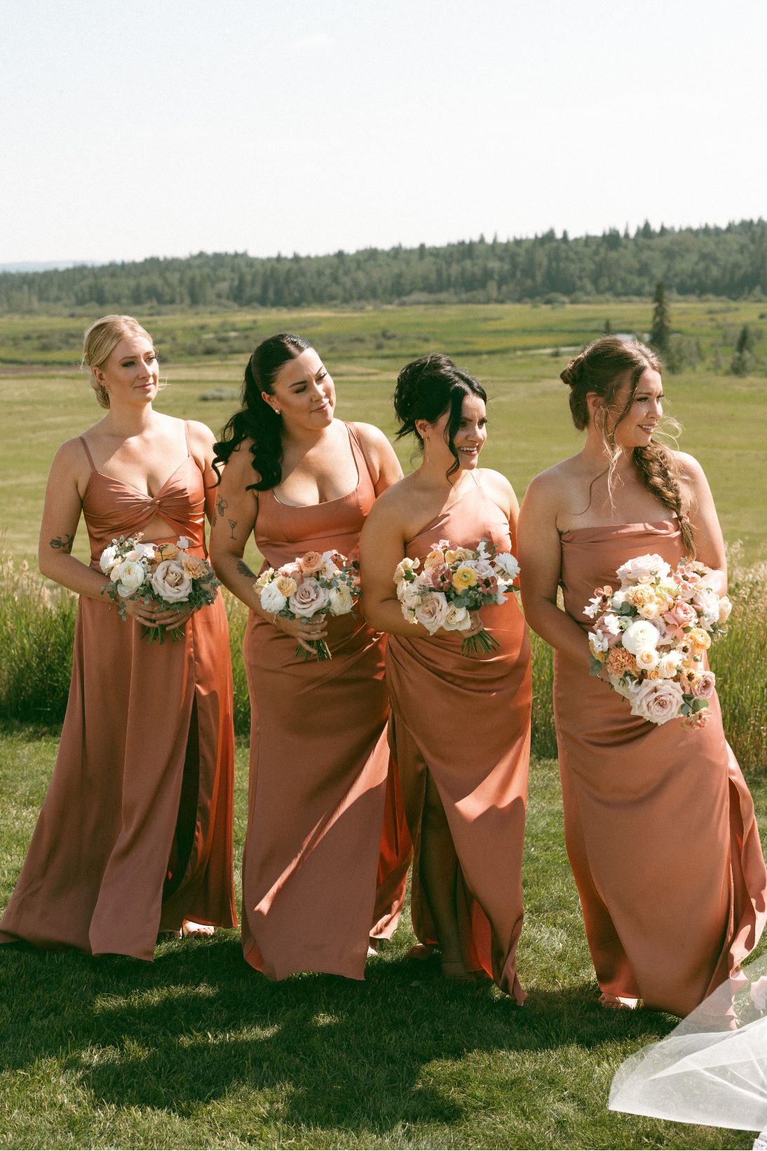 Bridesmaids lined up watching the happy couple during the ceremony.