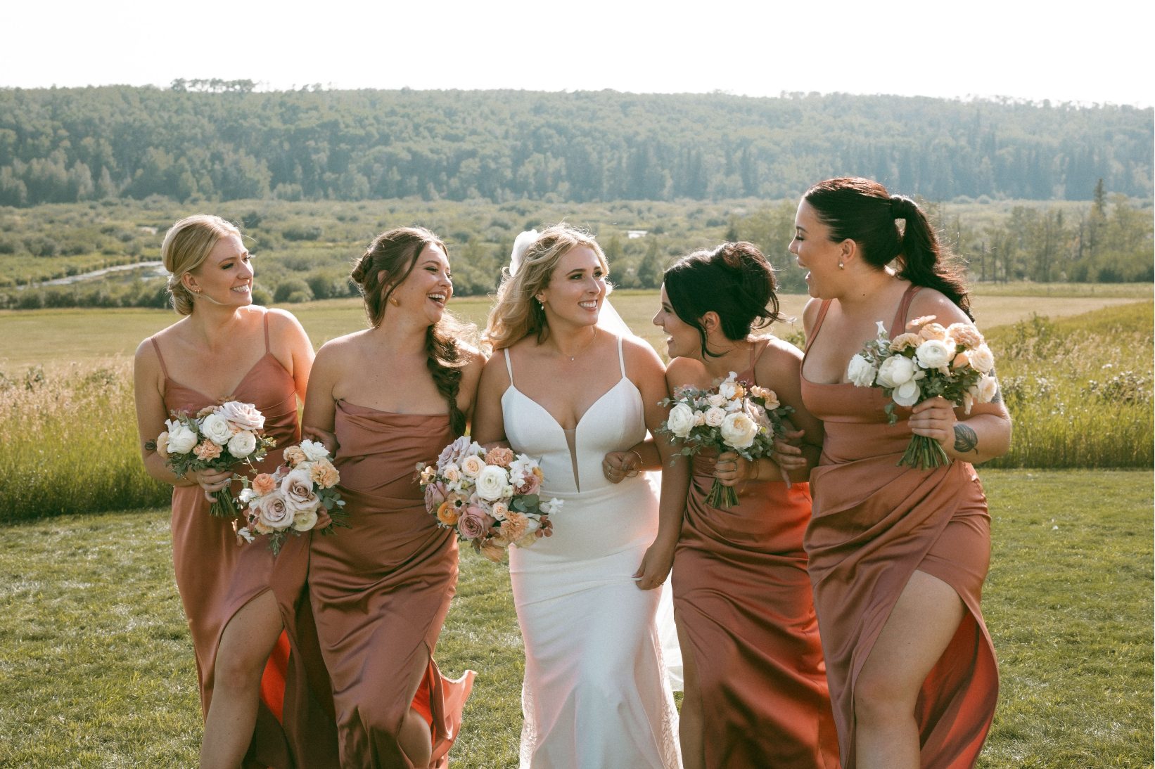 Katrina and her brides looking at each other chatting and laughing.