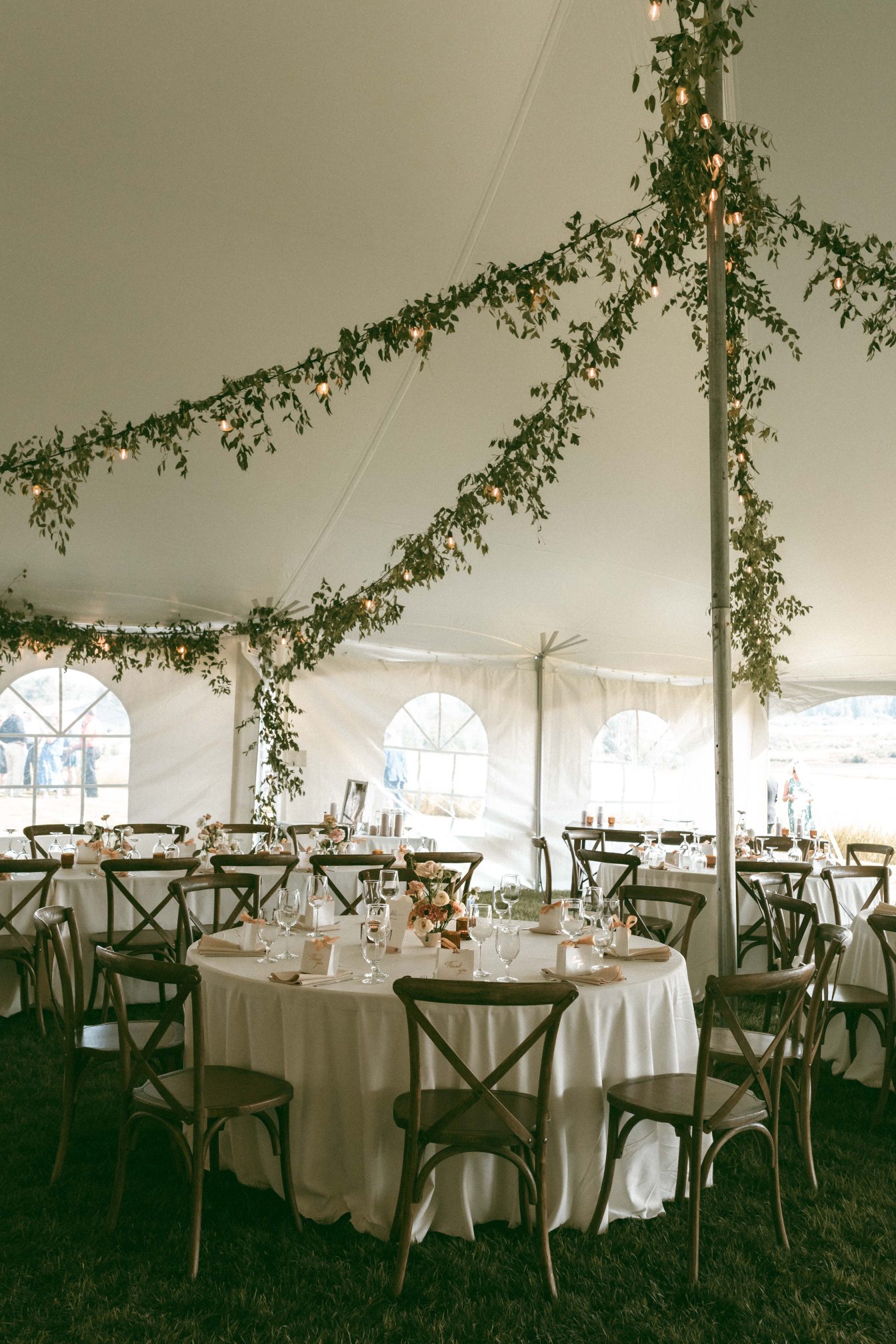 The reception set up with a mix of rectangular and round tables with the a touch of magic from the garlands draping across the ceiling.