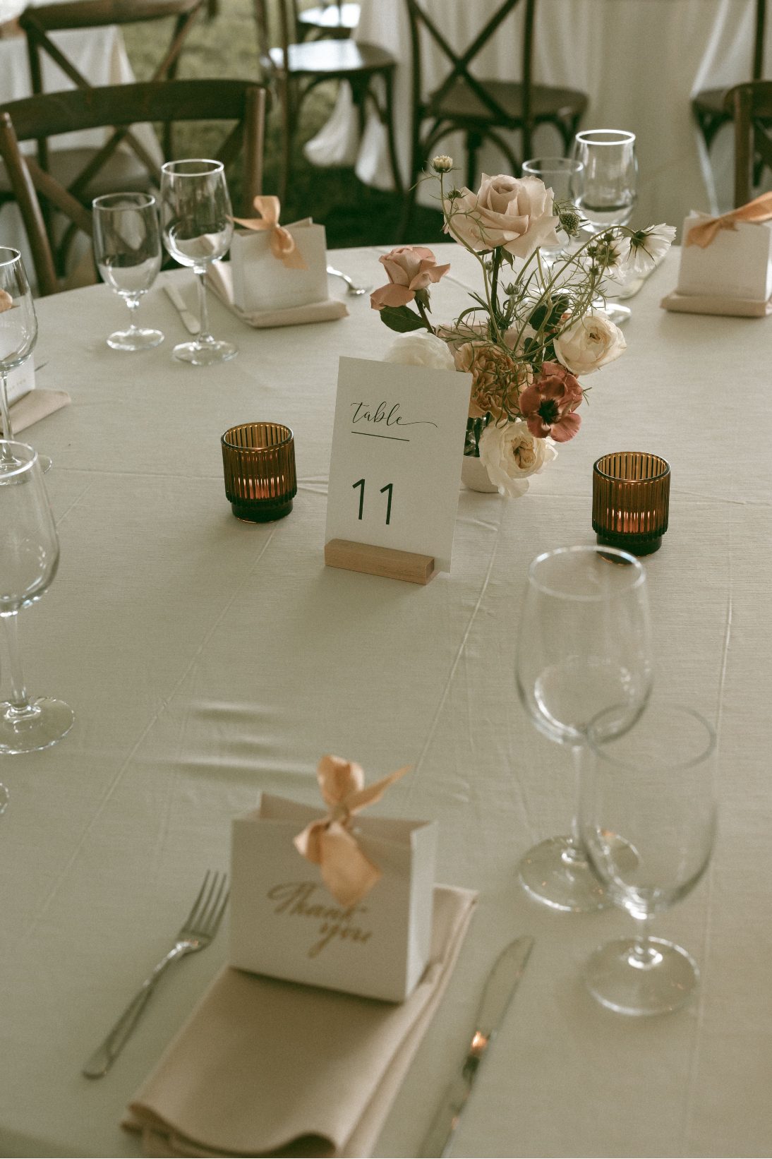 The beautiful ikebana centrepieces with amber glass tea lights and elegant table decor.