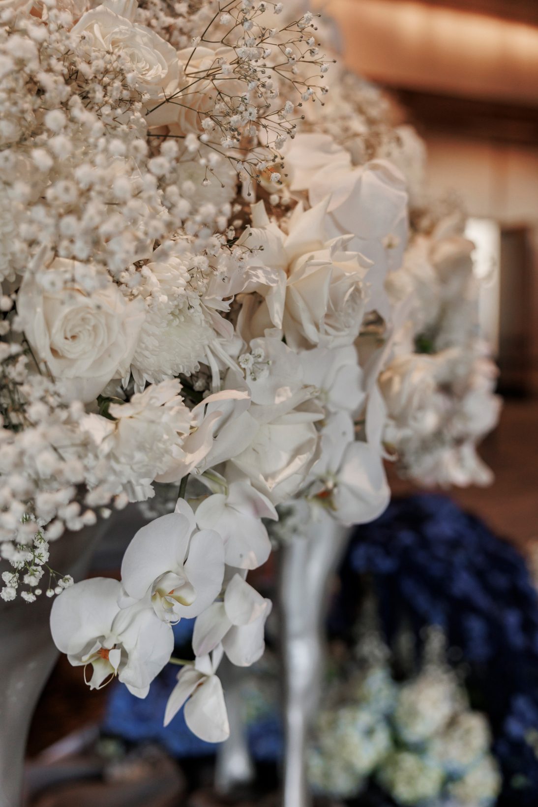 Detailed close up of cascading white blooms as Shania's coat splayed out behind her, made up of roses, chrysanthemums, carnations, baby's breath and ochids.