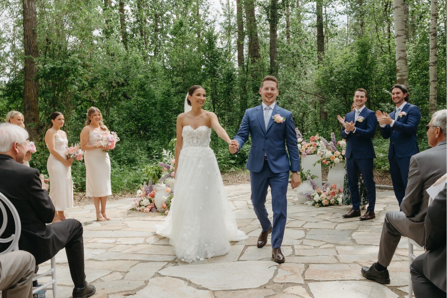 The bride and groom smiling radiantly as they walk down the aisle at the end of the cermony.