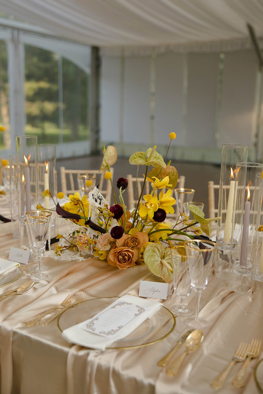 One f the many centrepieces running down the length of the table made up of roses, ranunculus, cymbidium orchids, anthurium, carnations, craspedia, kangaroo paw, calla lilies and amaranthus.