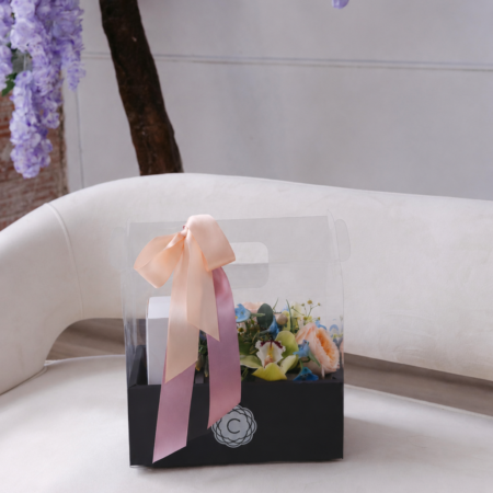 The Luxe Boutique is a black carry out box with our classic boutique box and a 10 pack of Queen Bee's Macarons