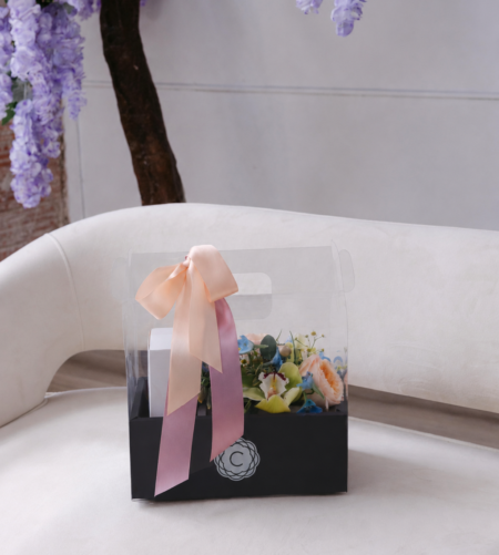 The Luxe Boutique is a black carry out box with our classic boutique box and a 10 pack of Queen Bee's Macarons
