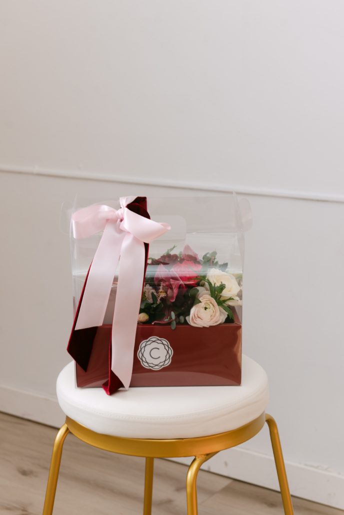 The Luxe Boutique from our Valentine's Day collection features our classic boutique box in a combo of red, pink and white paired with a box of Calyx Collection macarons presented in a red carry out container.