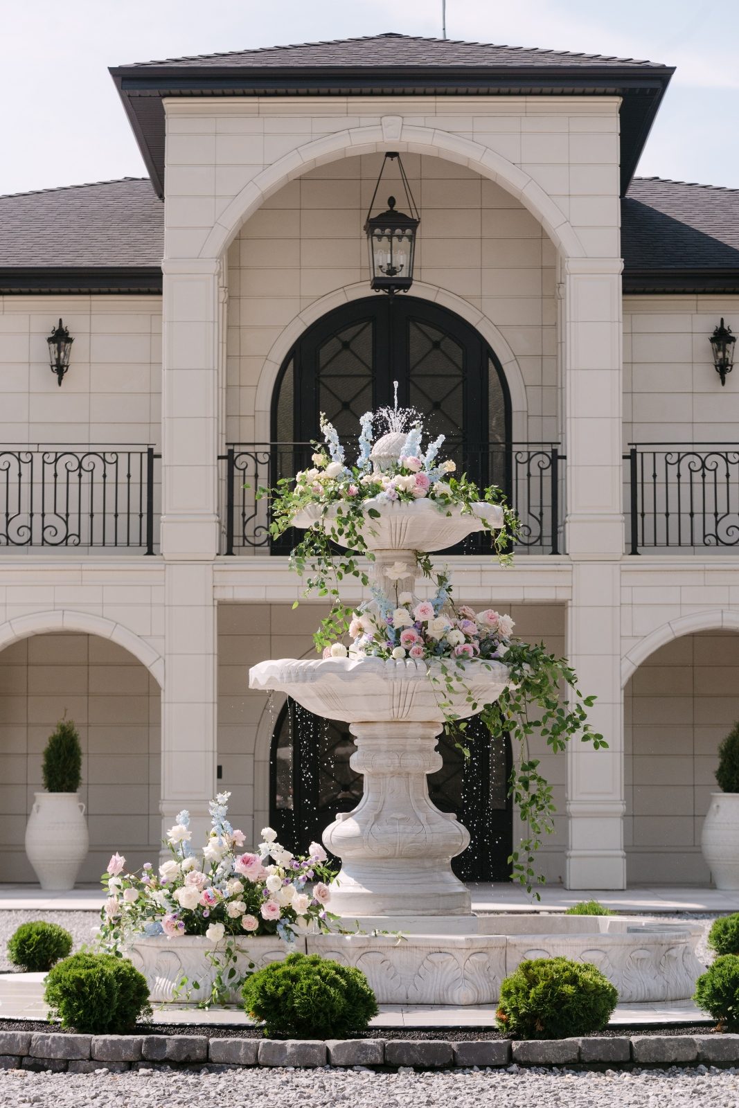Grand luxury wedding reception ceremony Fountain flowers with garden roses in pastel tones of white, blush, pink, pale blue and lavender, light purple at Archway Manor