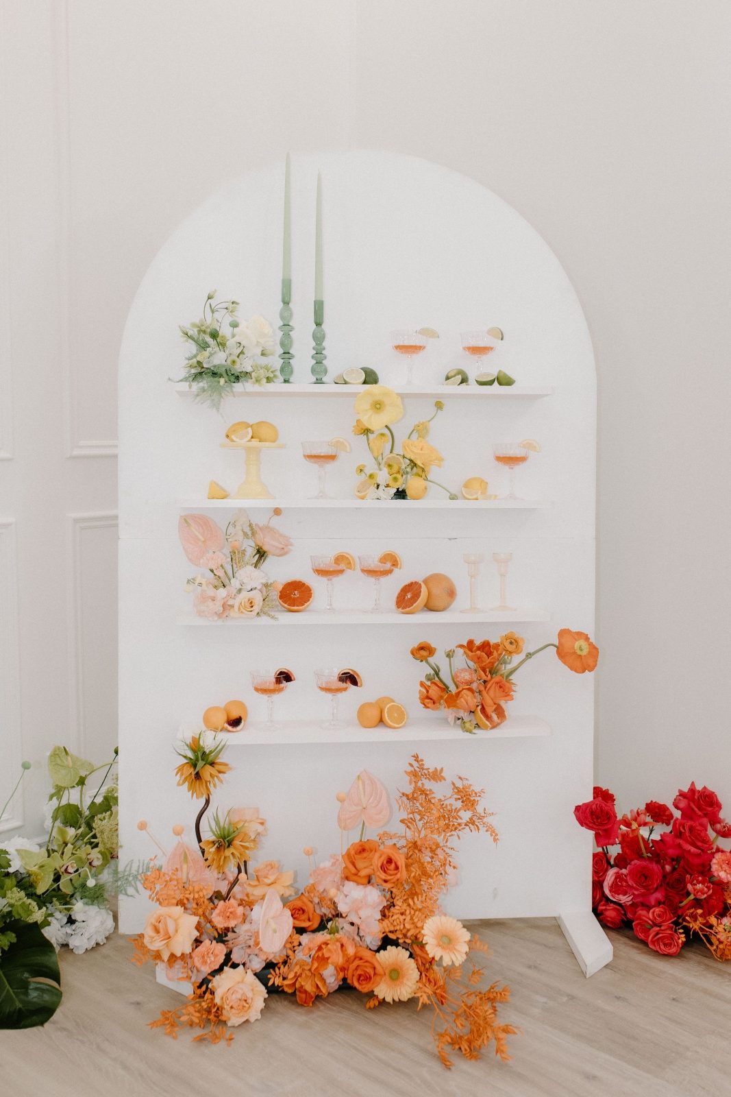 Colorblocked champagne wall in bright citrus tones of green, orange, yellow, pink and coral