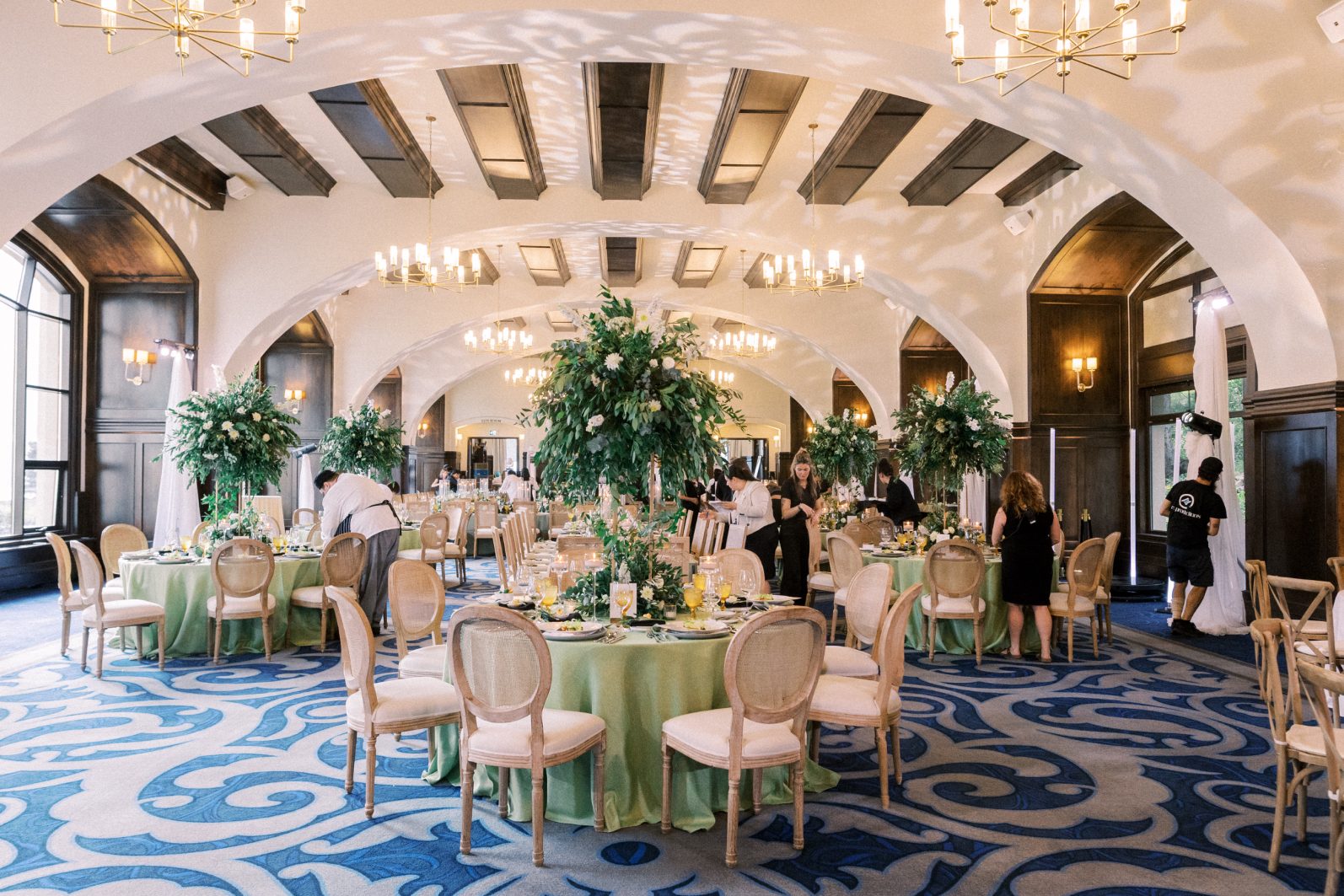 Reception Decor Grand reception space with arched ceilings, sage green table and tall, lush wedding centrepieces.