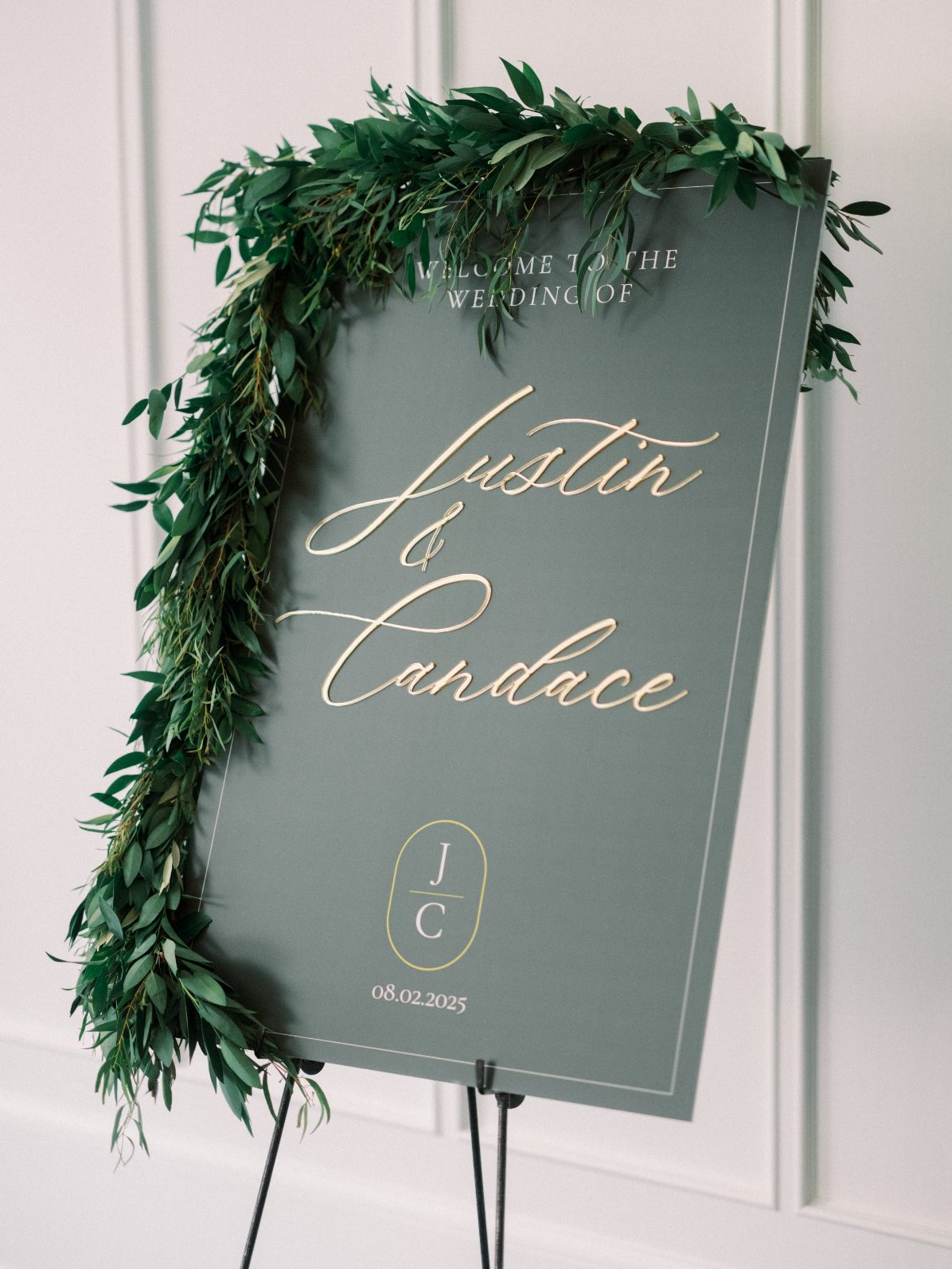 Welcome Sign Sage green welcome sign with cascading greenery for elegant green and white wedding celebration.