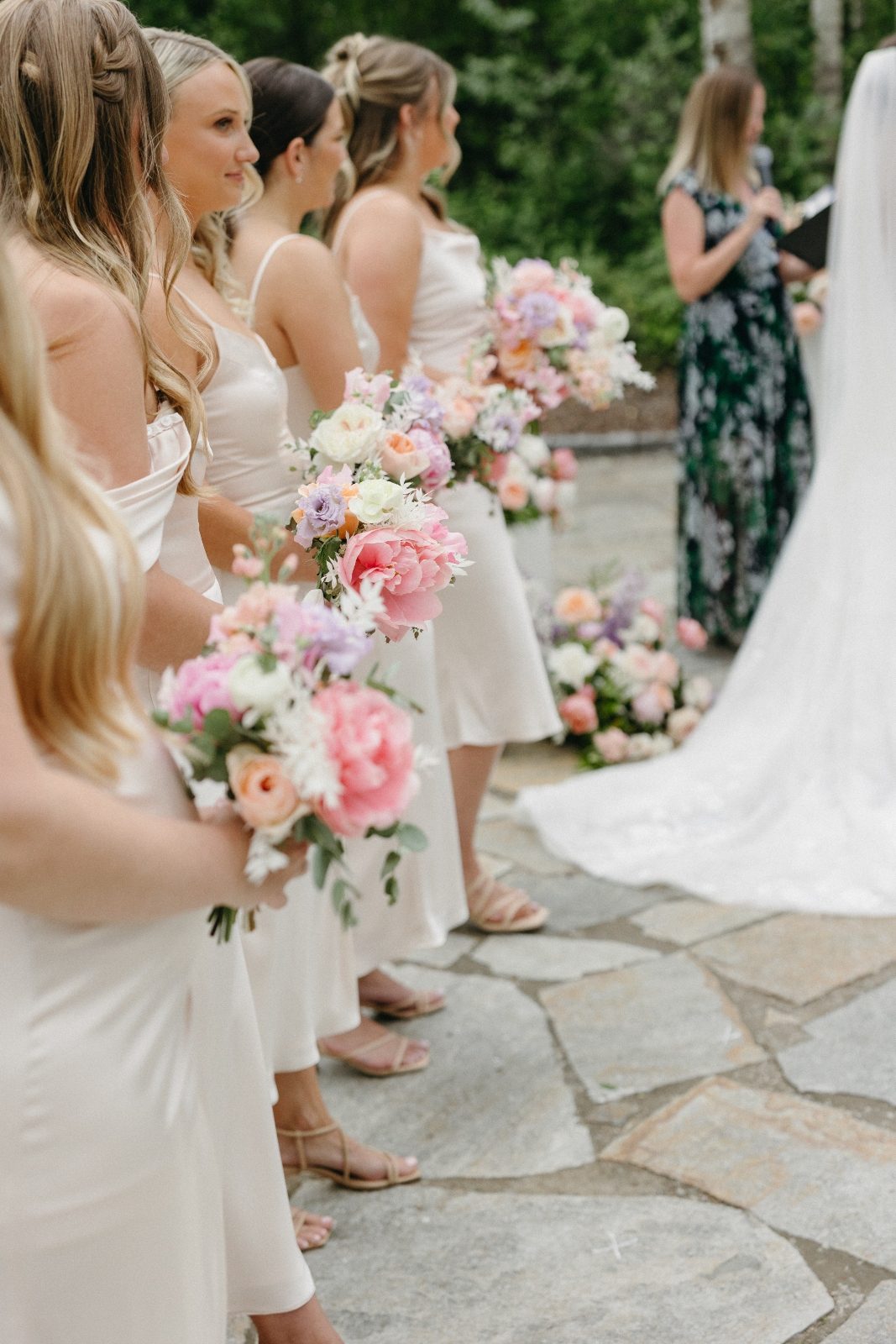 Bridesmaids in ivory with pastel spring bouquets