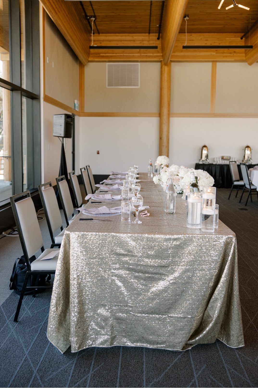 Head Table Long head table with gold sequinned table cloth, accented with floating candles and floral arrangements.