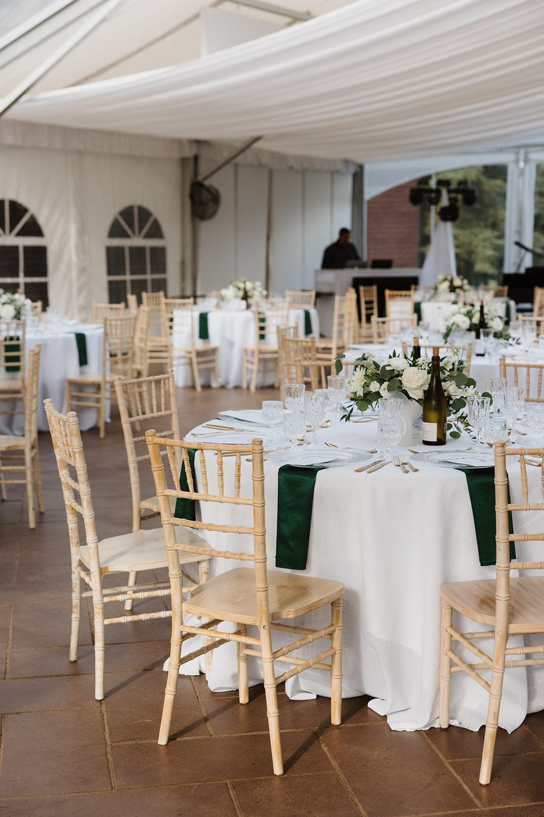 Cassidy + Adon White round guest tables at Hilltop Wedding Center accented by green linen napkins, and modern green and white centrepieces.