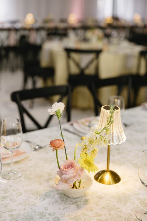 An airy ikebana inspired centrepiece featuring warm pastel stock, rose, daisy and ranunculus.