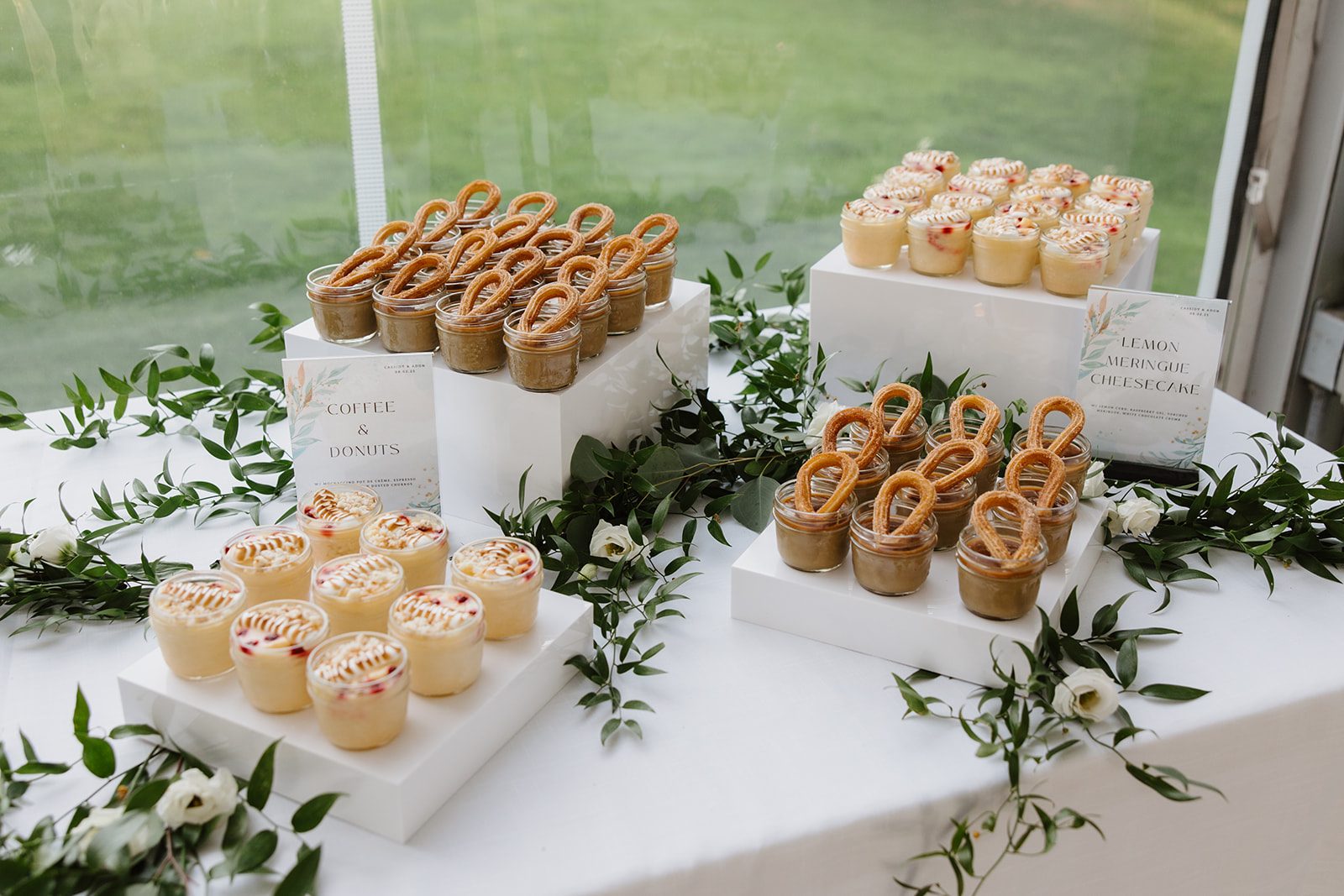 Cassidy + Adon Dessert table for the green and white reception at Hilltop Wedding Center, accented by sprigs of Italian Ruscus.