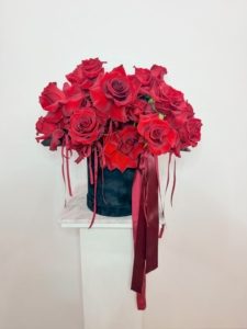 A beautiful black velvet hat box designed with reflexed red roses