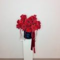 A beautiful black velvet hat box designed with reflexed red roses