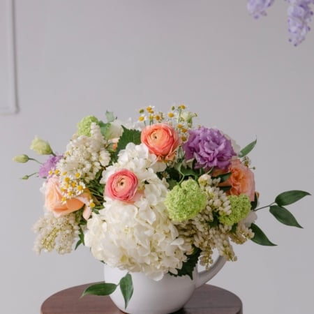 Brooke's Garden is a beautiful design from our Mother's Day collection in a white pitcher filled with pastel spring blooms.