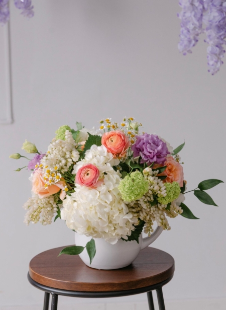 Brooke's Garden is a beautiful design from our Mother's Day collection in a white pitcher filled with pastel spring blooms.