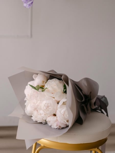 From our Mother's Day collection, a hand tied bouquet of big, fluffy peony blooms accented with greenery.