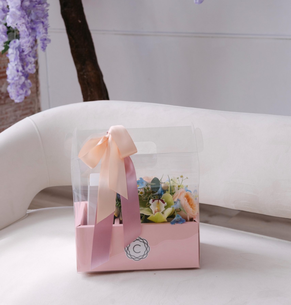 Calyx | Mothers Day 2026 The Luxe Boutique is from our Mother's Day collection, featuring a boutique box and a box of Queen Bee macarons displayed in a super cute carrying display case.